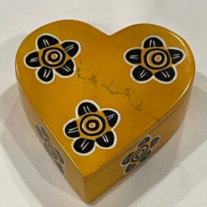 Yellow heart-shaped soapstone box with black flowers