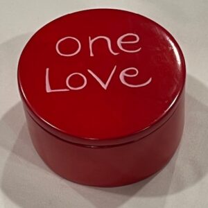 Red round soapstone box with one love design