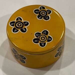 Yellow circular soapstone box with black flowers