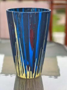 a blue and yellow painted cup